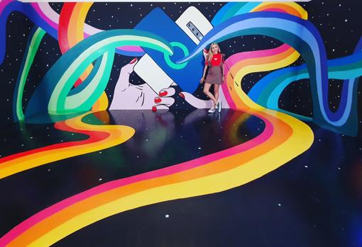 La artista, junto a uno de sus murales